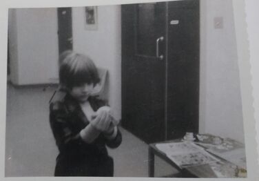 Continuity Polaroid of Danny holding the ball.