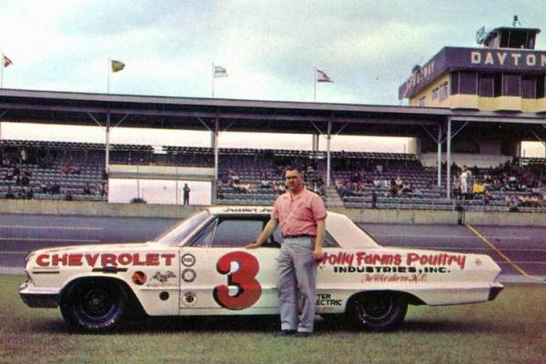 Junior Johnson next to his Chevrolet at the event.