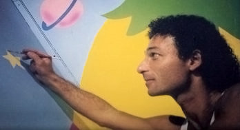 An unknown employee painting the set of the puppet show.