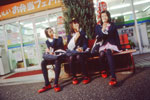 Three girls outside of a convenience store