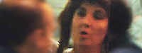Closeup still frame of Carlene Moore as the prostitute.