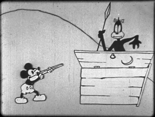 Mickey pointing a shotgun at a black stereotype.