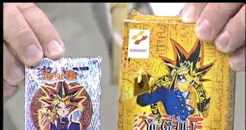 Gilberto showing two Yu-Gi-oh booster packs to the camera
