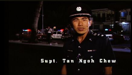 Actual police officer paying respect to Detective Goh's fatal shooting.