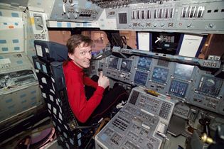 Murray in the cockpit of a space shuttle.