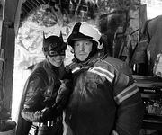 Set photo of Batgirl with a firefighter.