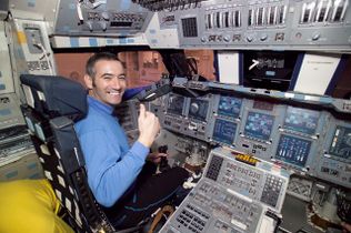 Anthony in the cockpit of a space shuttle.