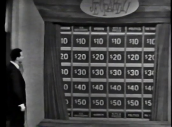 The curtain revealing the board for round 1 (Note that the categories are on the bottom as well as the top).