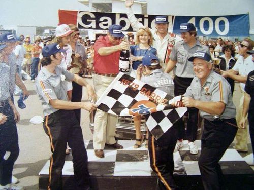 Baker celebrating with his crew in Victory Lane.