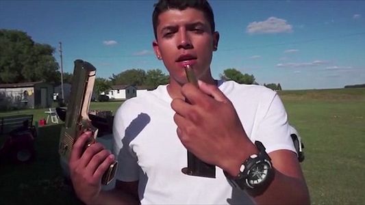 Ruiz holding the Desert Eagle and bullet that would later claim his life.