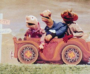 Hank, Sam, and Moldy Hay riding a car from an Esskay Meats commercial.