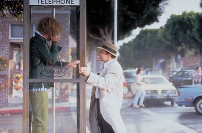 Robogadget throwing a phone booth as the person inside attempts to call 911 to report him.