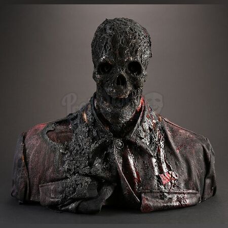 The bust used for the original version of the scene after being burned.[7]