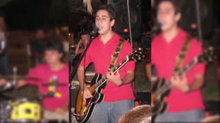 (3) Screenshot from the Youtube video featuring the song snippet. Luigi Calagna playing the electric guitar with his band during a live event.