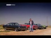 Jeremy Clarkson with a group of Ford Mustangs.
