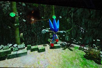 Sonic falling to the floor after knocking down a breakable wall near a rope.