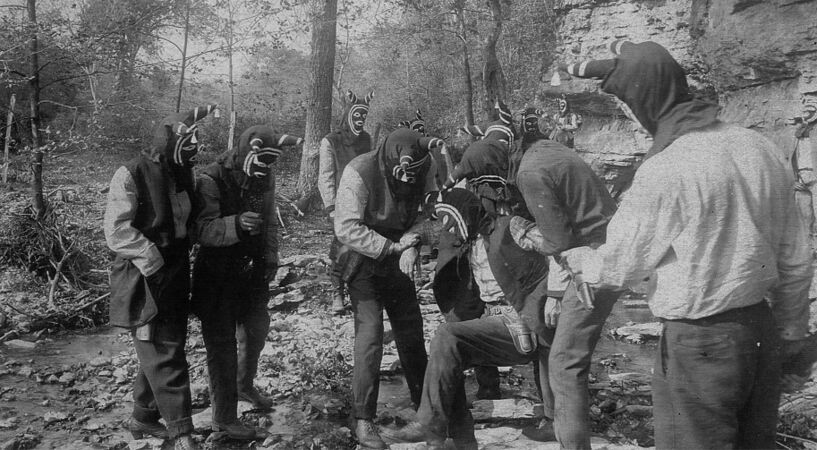 A promotional image for The Shepherd of the Hills play featuring Bald Knobbers wearing their distinctive masks