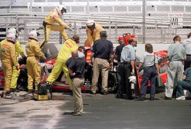 Adam Petty’s car surrounded by track marshals following the crash.