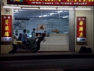 Ah Huat (running) who had just shot a restaurant owner (Yellow-Tan Shirt; Left; collapsing)