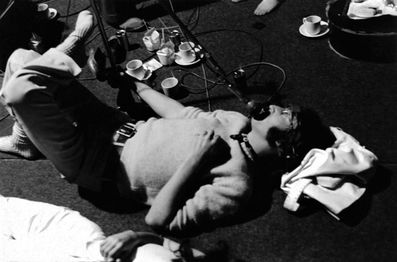 John Lennon laying down on the floor of EMI Studios Studio 3, recording vocals for "Revolution 1" (Take 20). 31st May, 1968 – photo by Tony Bramwell