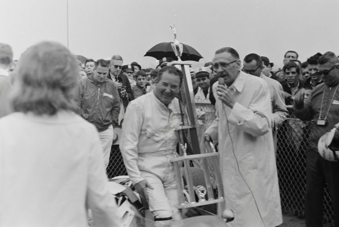 Ward being interviewed with the trophy following the race.