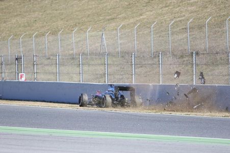 The McLaren crashes into the wall.