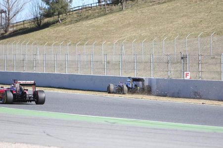 The McLaren grinds to a halt as Vettel drives by.