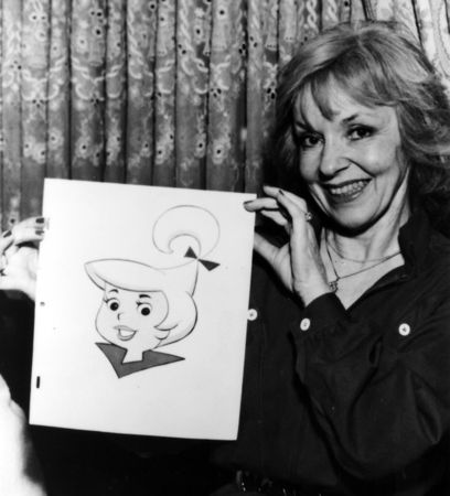 Janet Waldo posing with an image of Judy Jetson.