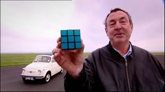 Nick Mason of Pink Floyd holds up a Rubik's Cube.